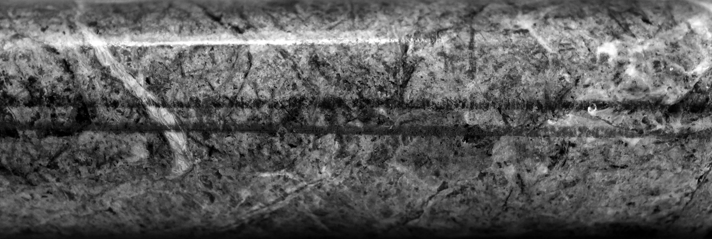 A length of drill core, banded across its width.