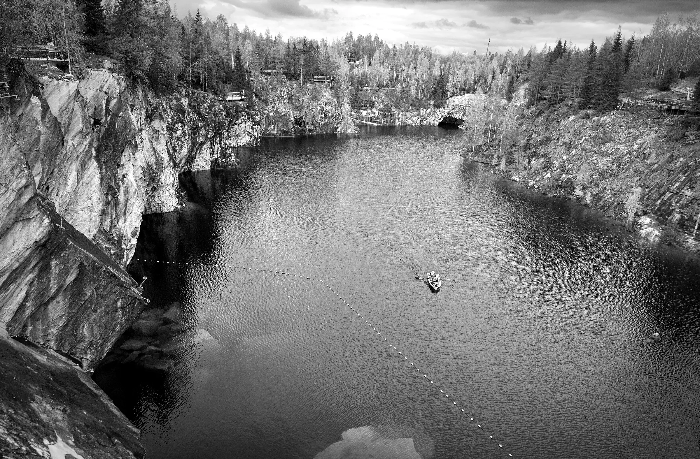 A worked-out marble quarry, the cut faces standing above water.