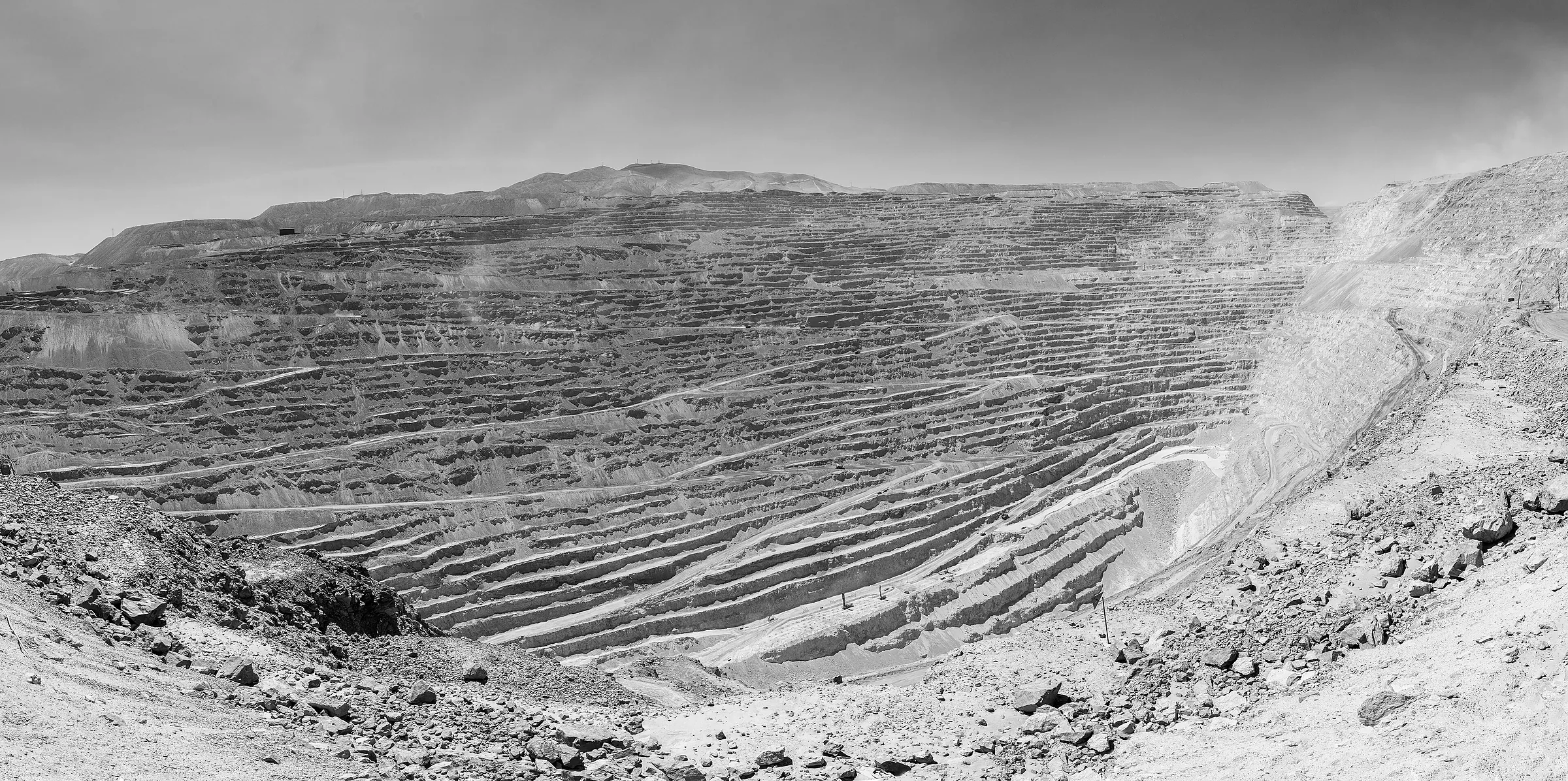 An open pit cut in benches, seen across the void.